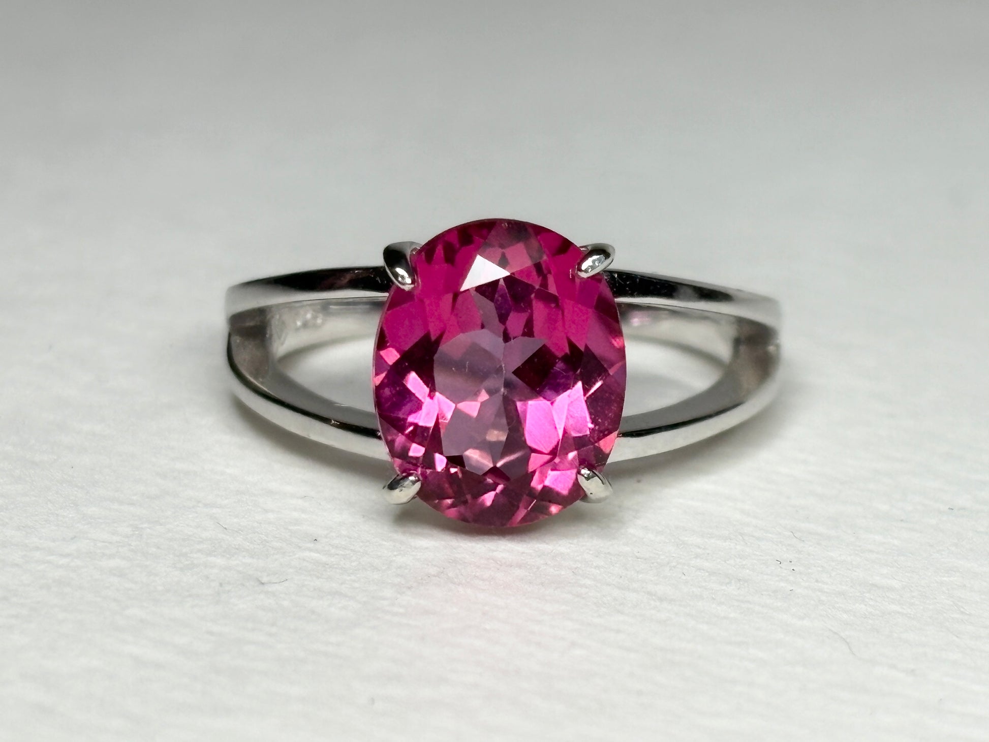 Sterling silver ring with a large oval pink topaz and a split shank.