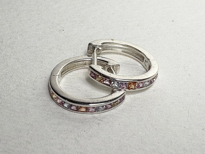 Sterling silver huggie hoop earrings with princess-cut multi-color sapphires.
