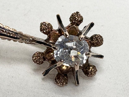 Antique 14k gold brooch with a central paste gem and enamel detailing.