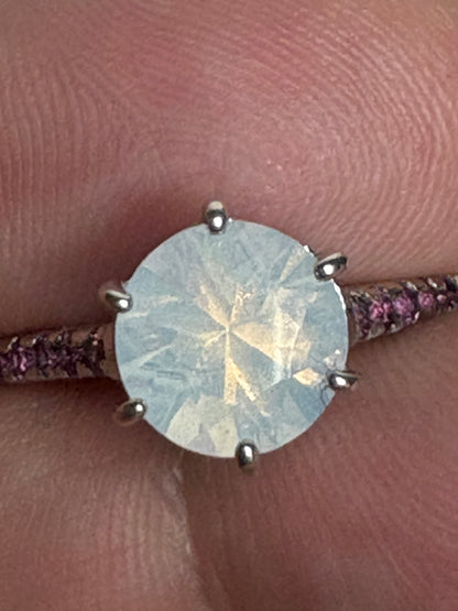 A sterling silver ring with a milky white quartz and rhodolite garnets.