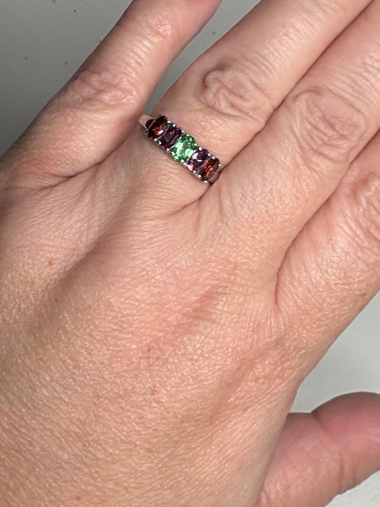 Sterling silver ring with almandine, rhodolite, and tsavorite garnets.