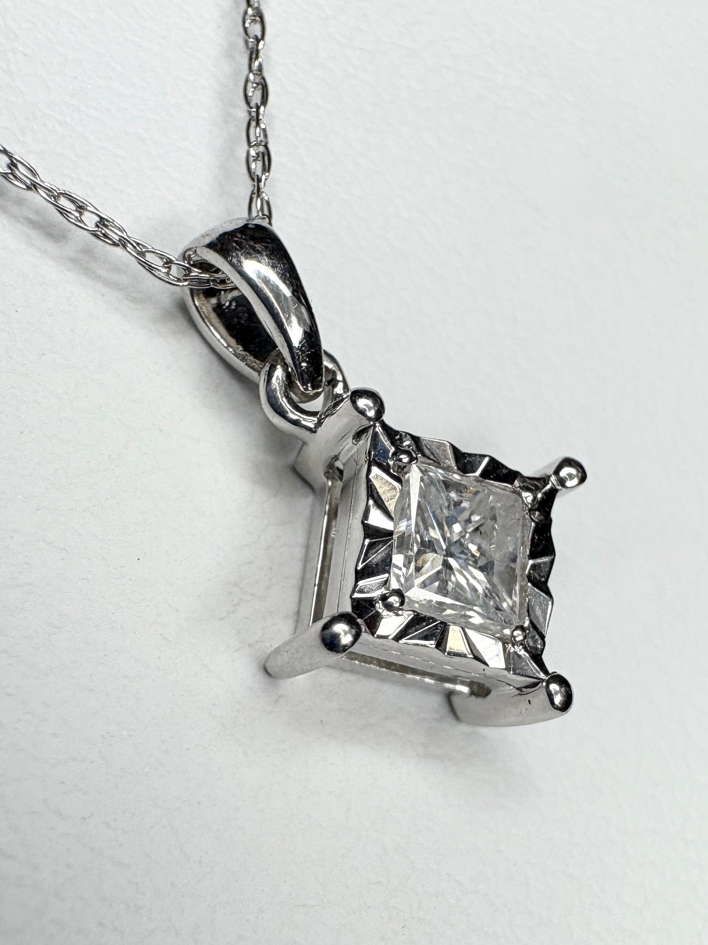 Princess cut diamond pendant necklace in 10k white gold.