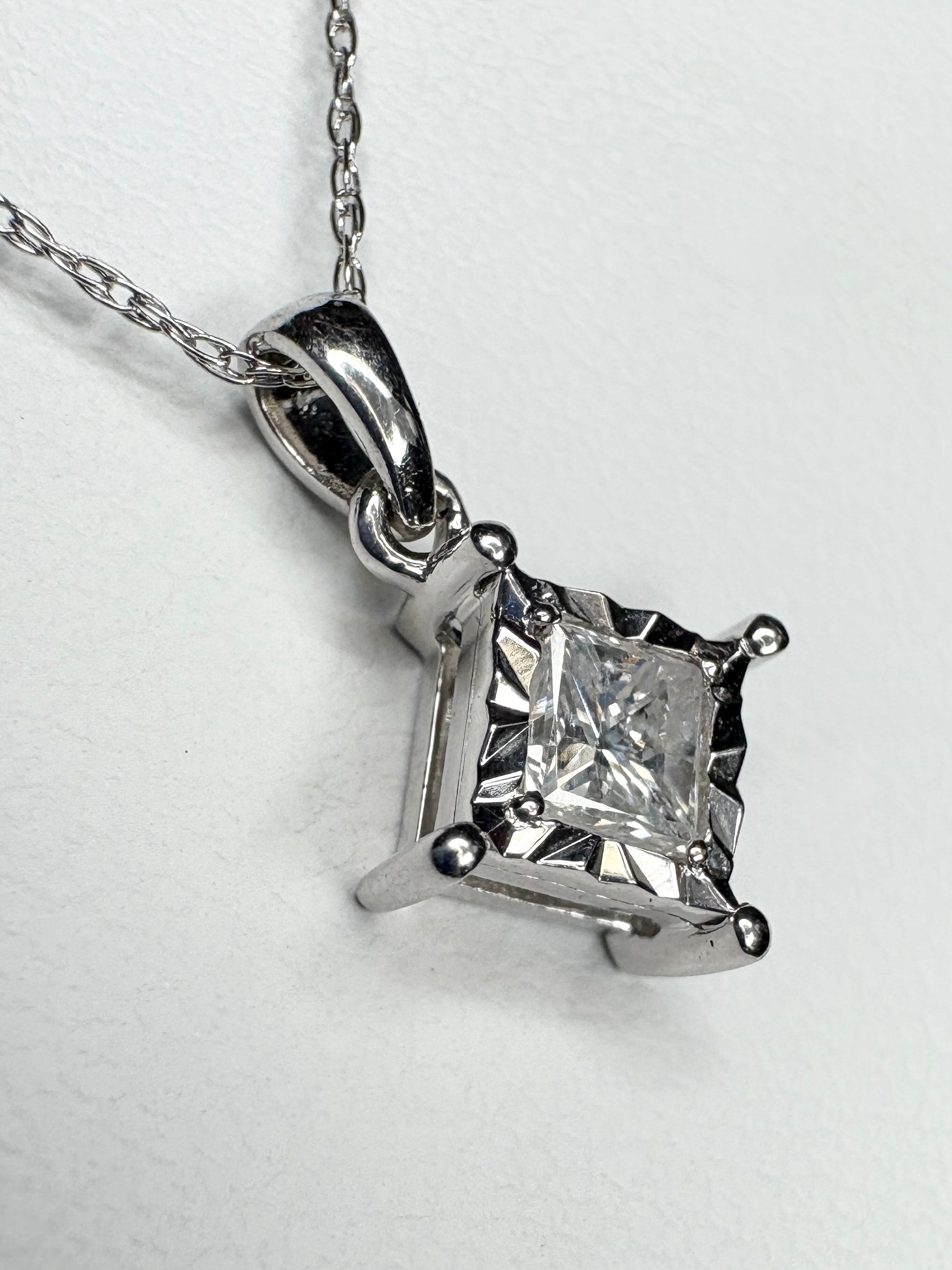 Princess cut diamond pendant necklace in 10k white gold.