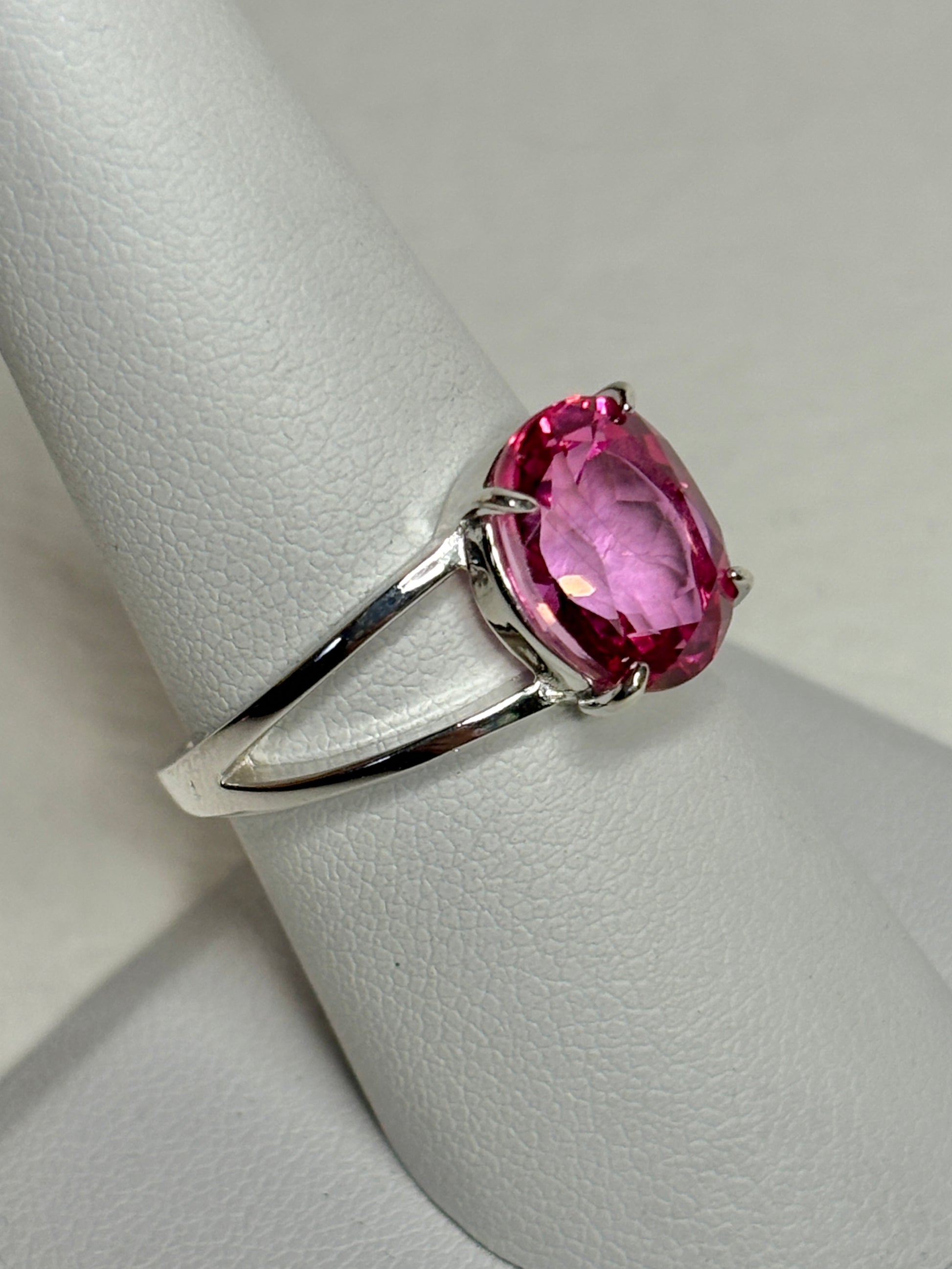 Sterling silver ring with a large oval pink topaz solitaire and split shank.
