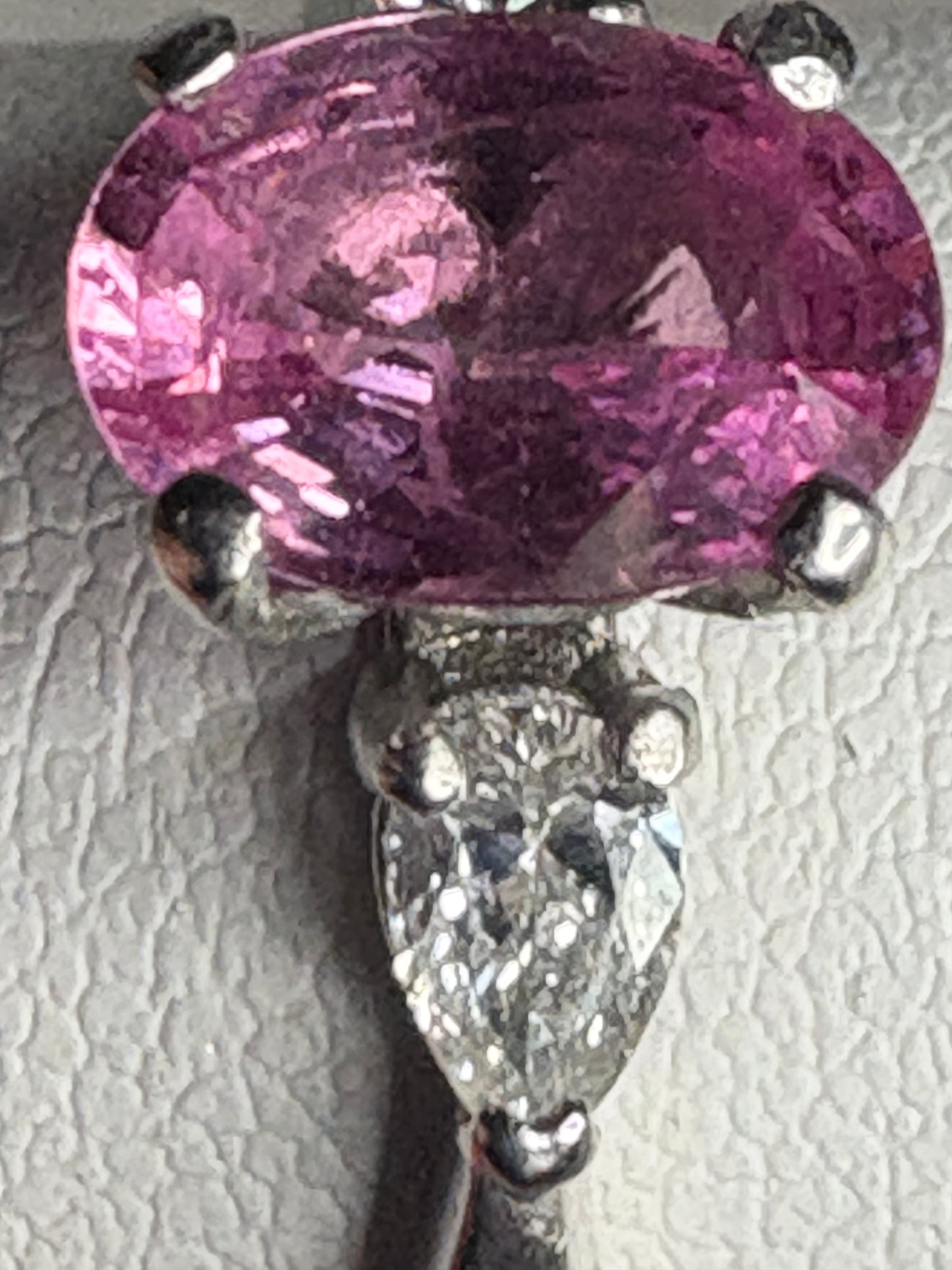 Pink sapphire and pear-shaped diamond ring in platinum.