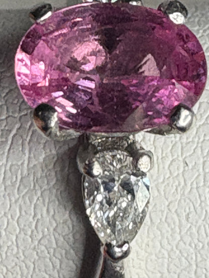 Pink sapphire and pear-shaped diamond ring in platinum.
