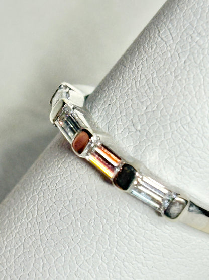 A white gold band ring with baguette-cut moissanite stones.