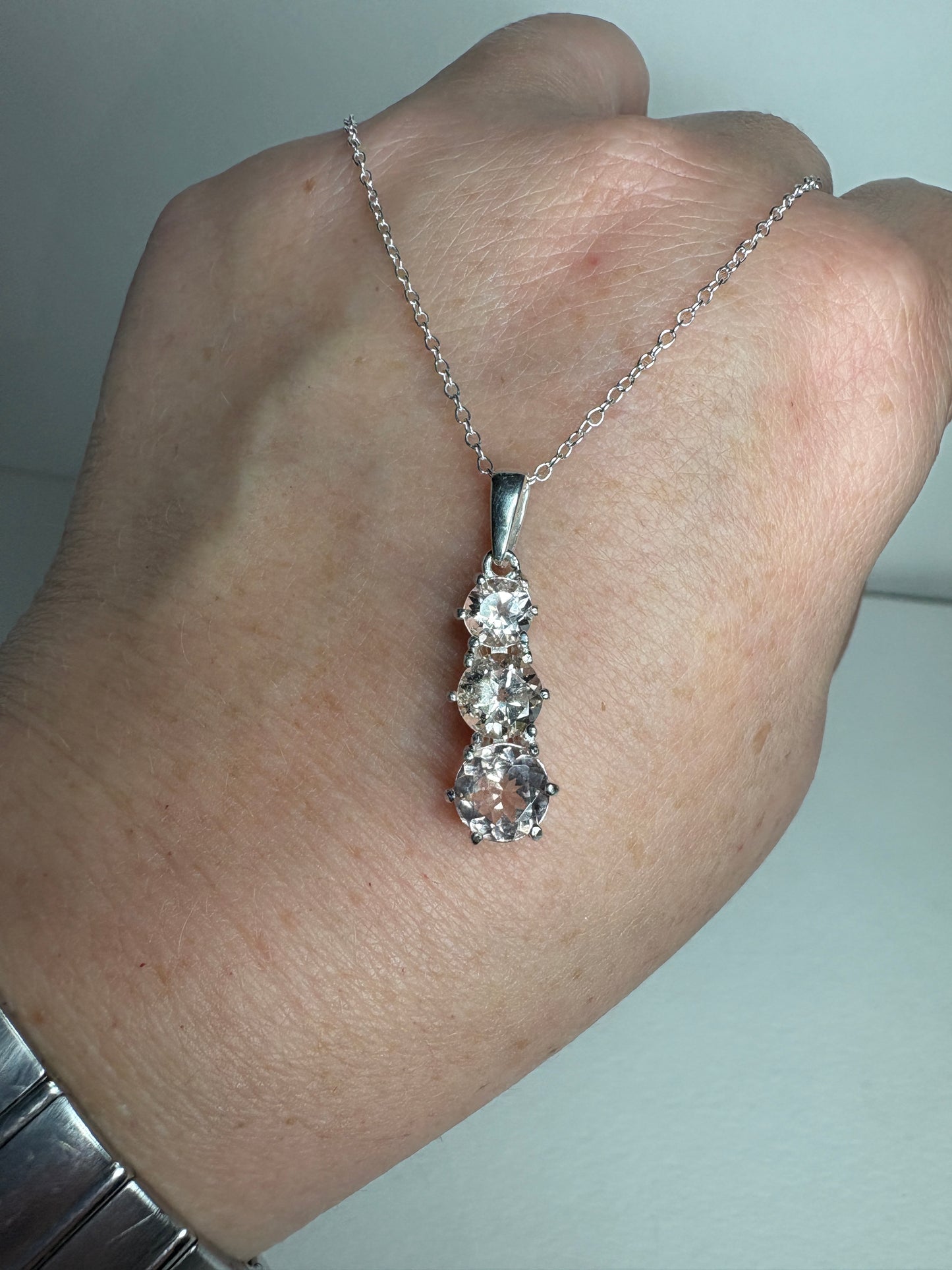 Sterling silver necklace with three natural morganite stones.