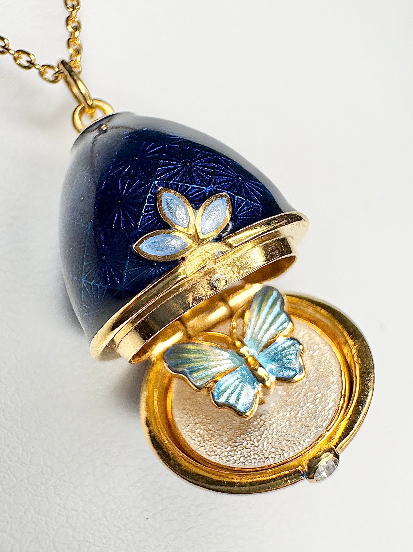 Opens. Silver. Gold Plated Blue Egg Locket with Butterfly Surprise. Diamond.