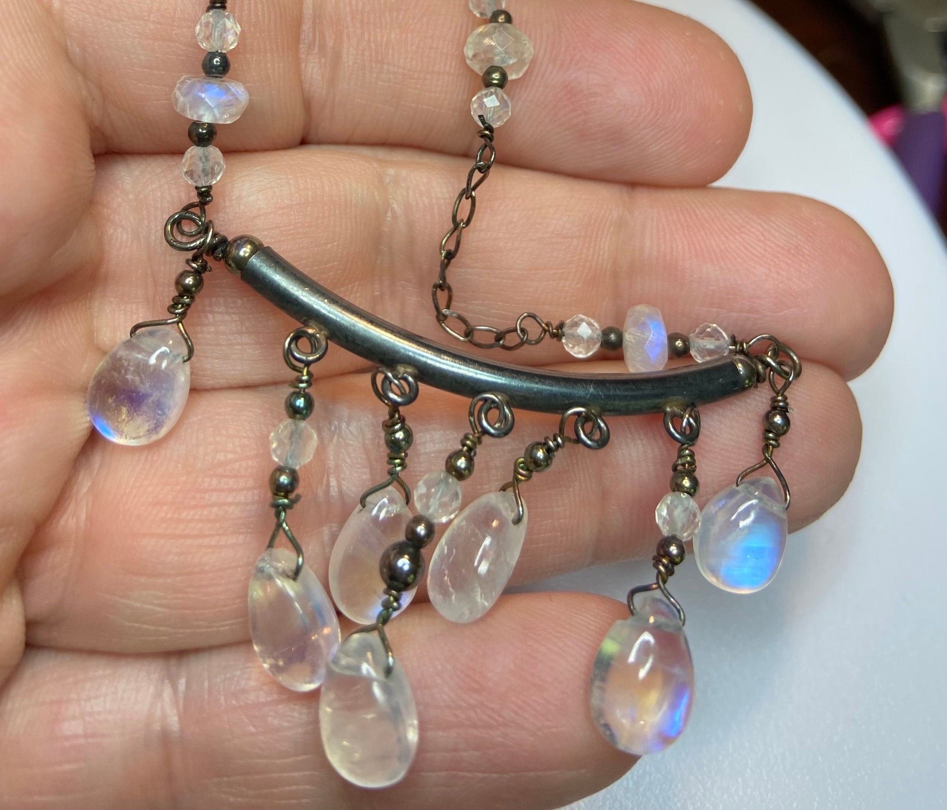 Sterling silver wire-wrapped necklace with rainbow moonstone teardrops and rondelles.