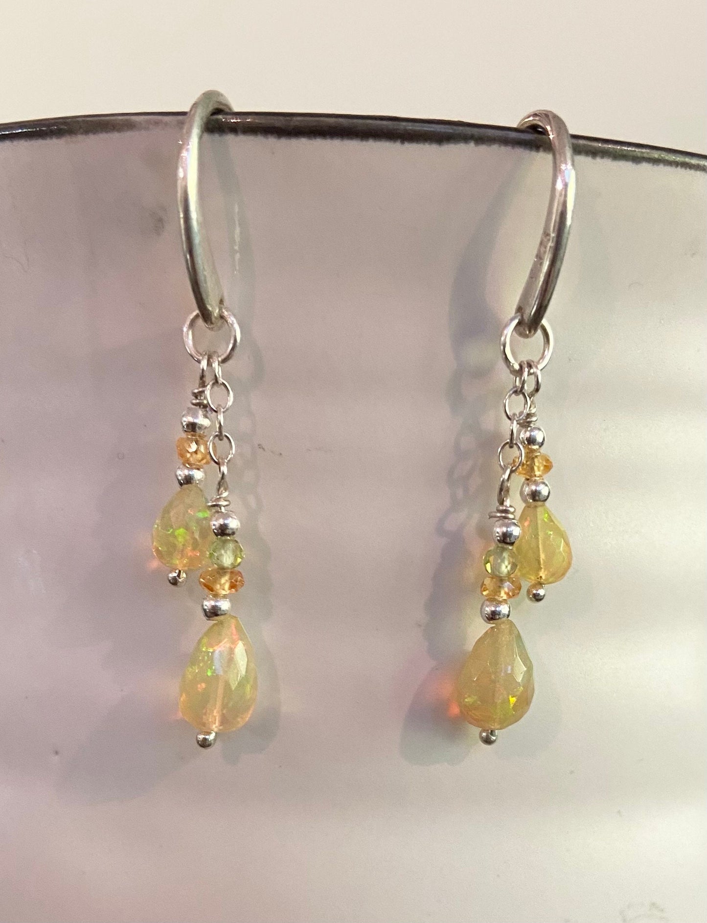 Sterling silver dangle earrings with Ethiopian yellow opal, peridot, and spessartite.