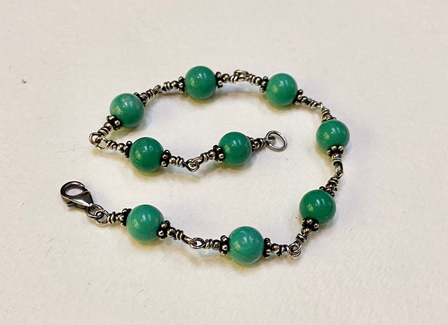 Sterling silver bracelet with blue jasper beads and a lobster clasp.