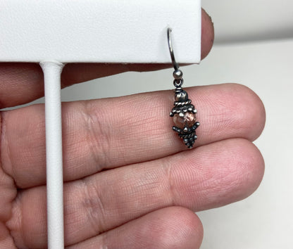 Sterling silver dangle earrings with a faceted Oregon sunstone bead.