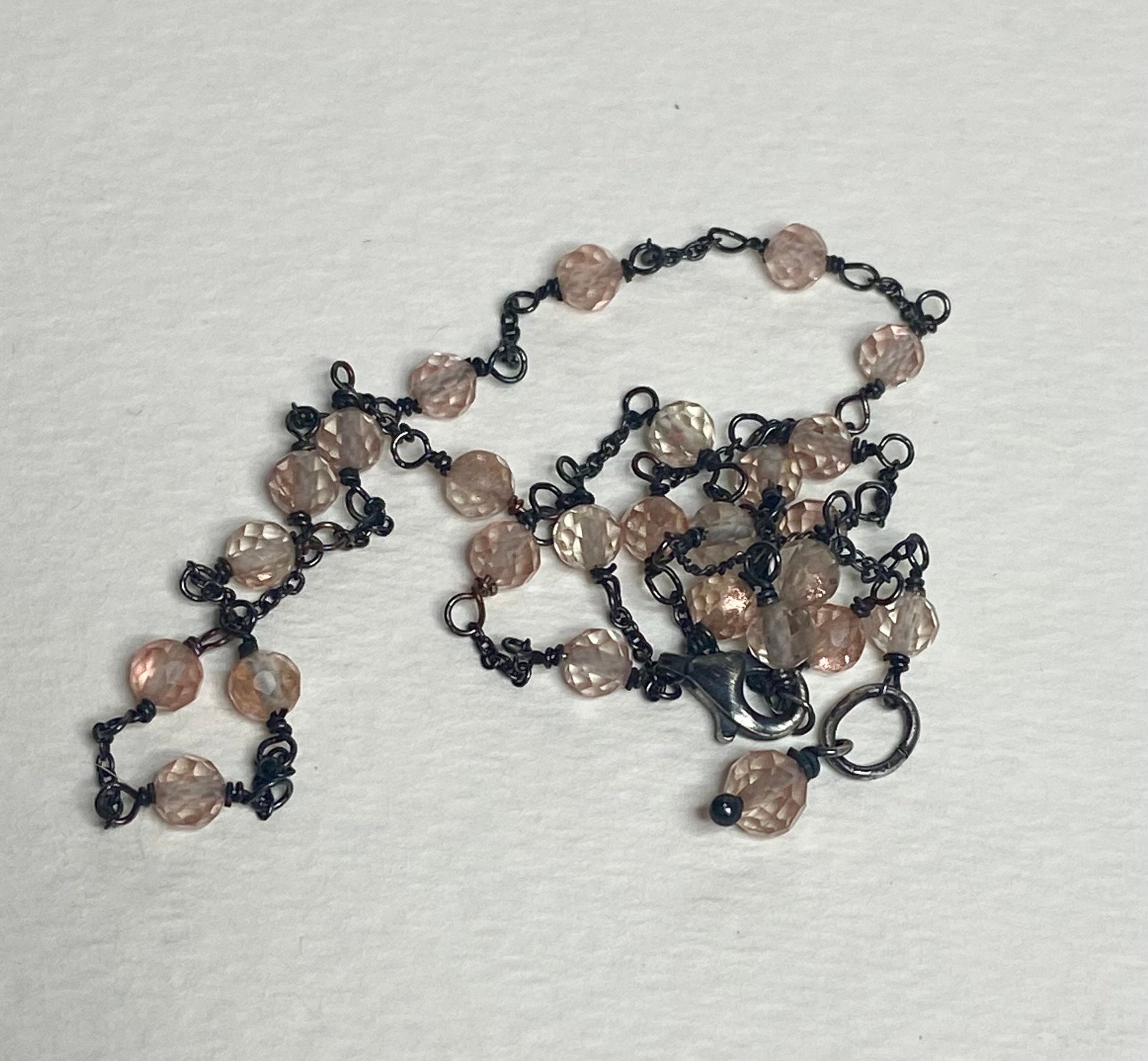 Adjustable sterling silver necklace with peach Oregon sunstone beads.