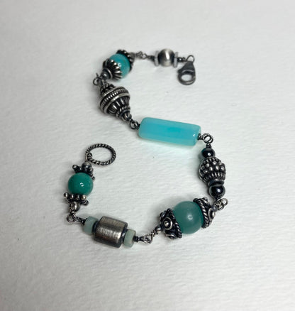 Eclectic sterling silver bracelet with blue beads and ornate silver accents.