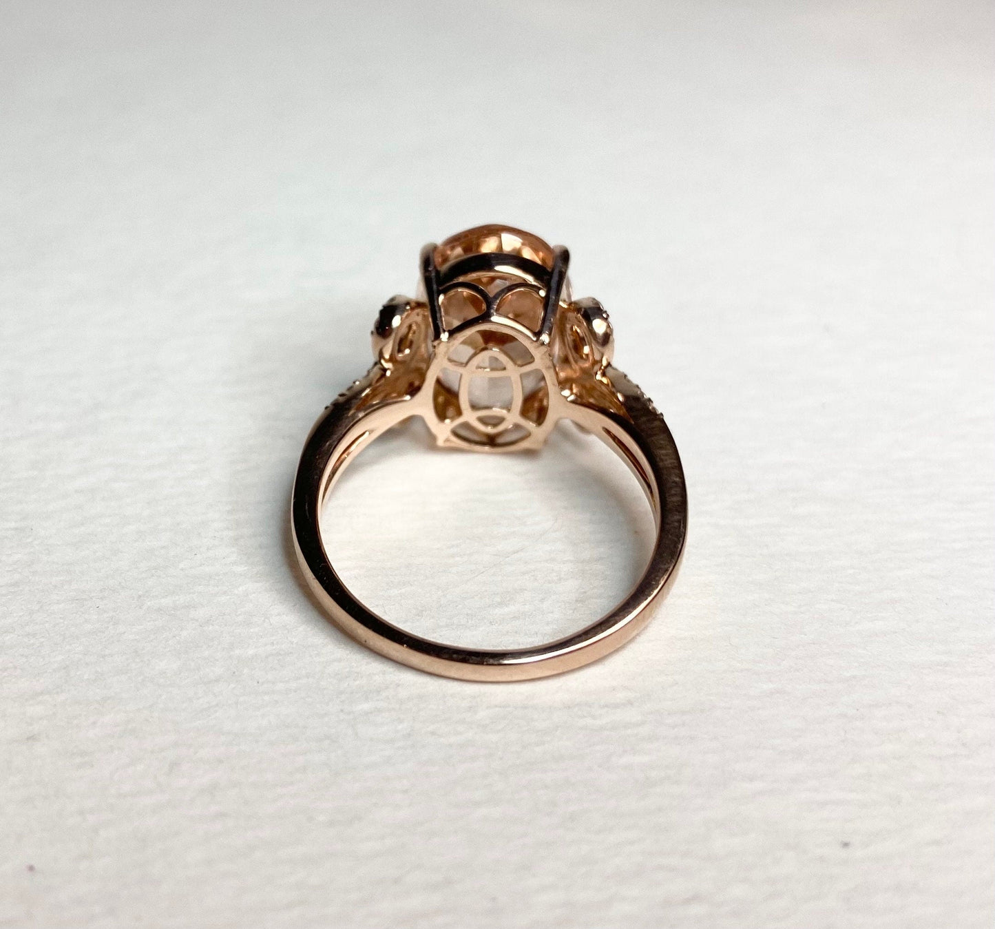 Oval morganite and diamond bow ring in rose gold.