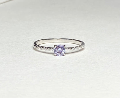 Sterling silver ring with a round tanzanite and small accent stones.