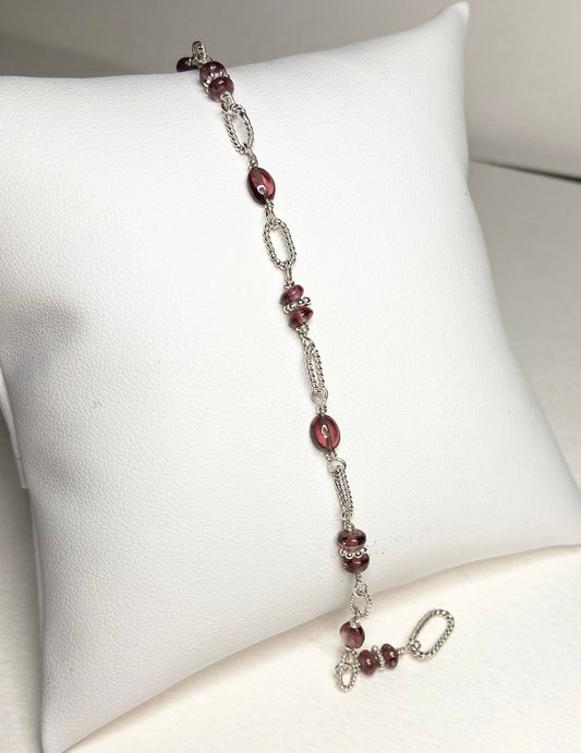 Sterling silver bracelet with oval and round rhodolite garnet beads.