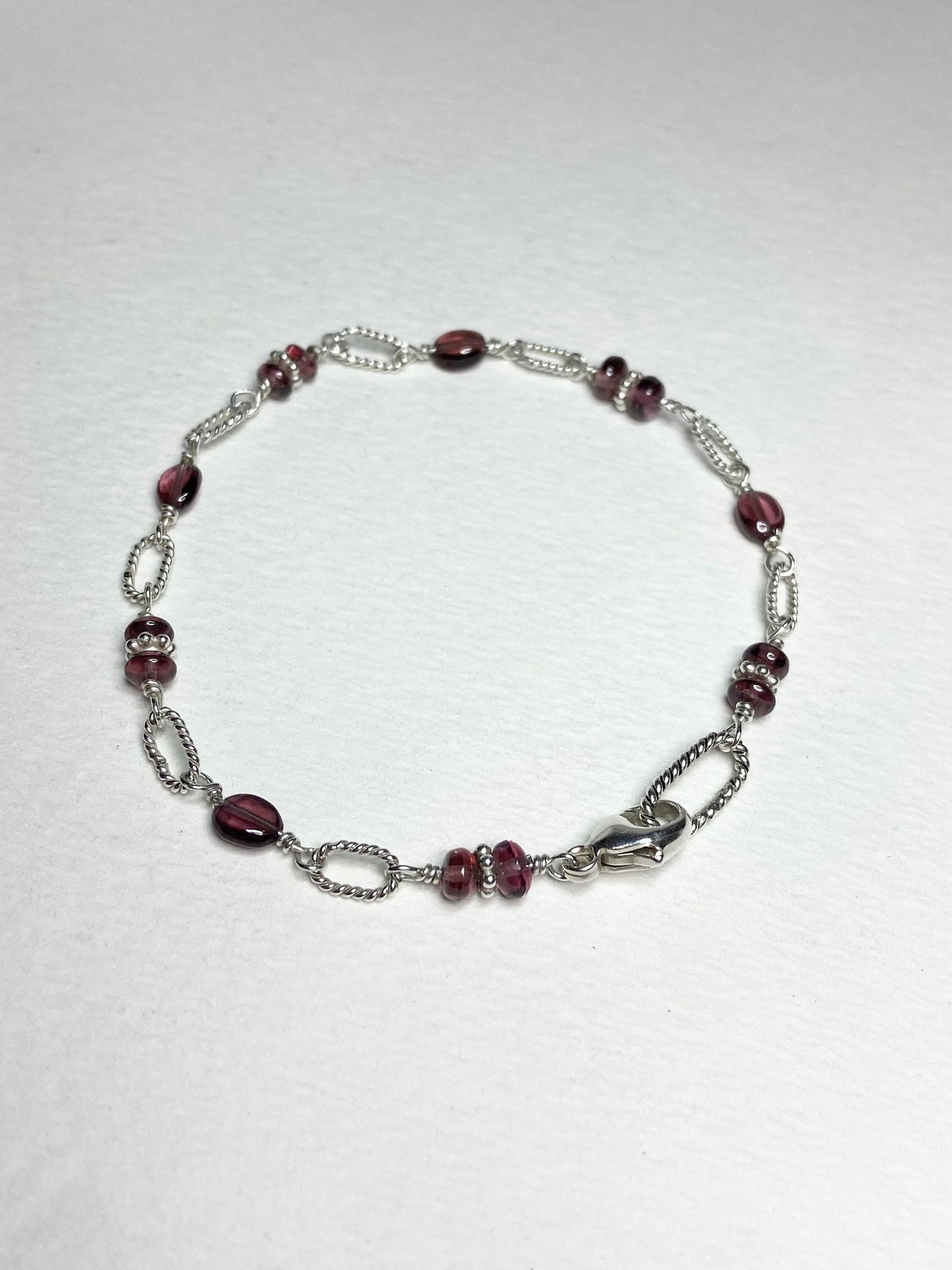 Malawi rhodolite garnet sterling silver beaded bracelet with a lobster clasp.