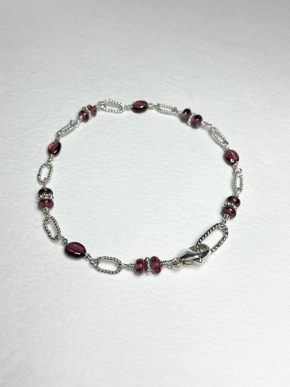 Malawi rhodolite garnet sterling silver beaded bracelet with a lobster clasp.