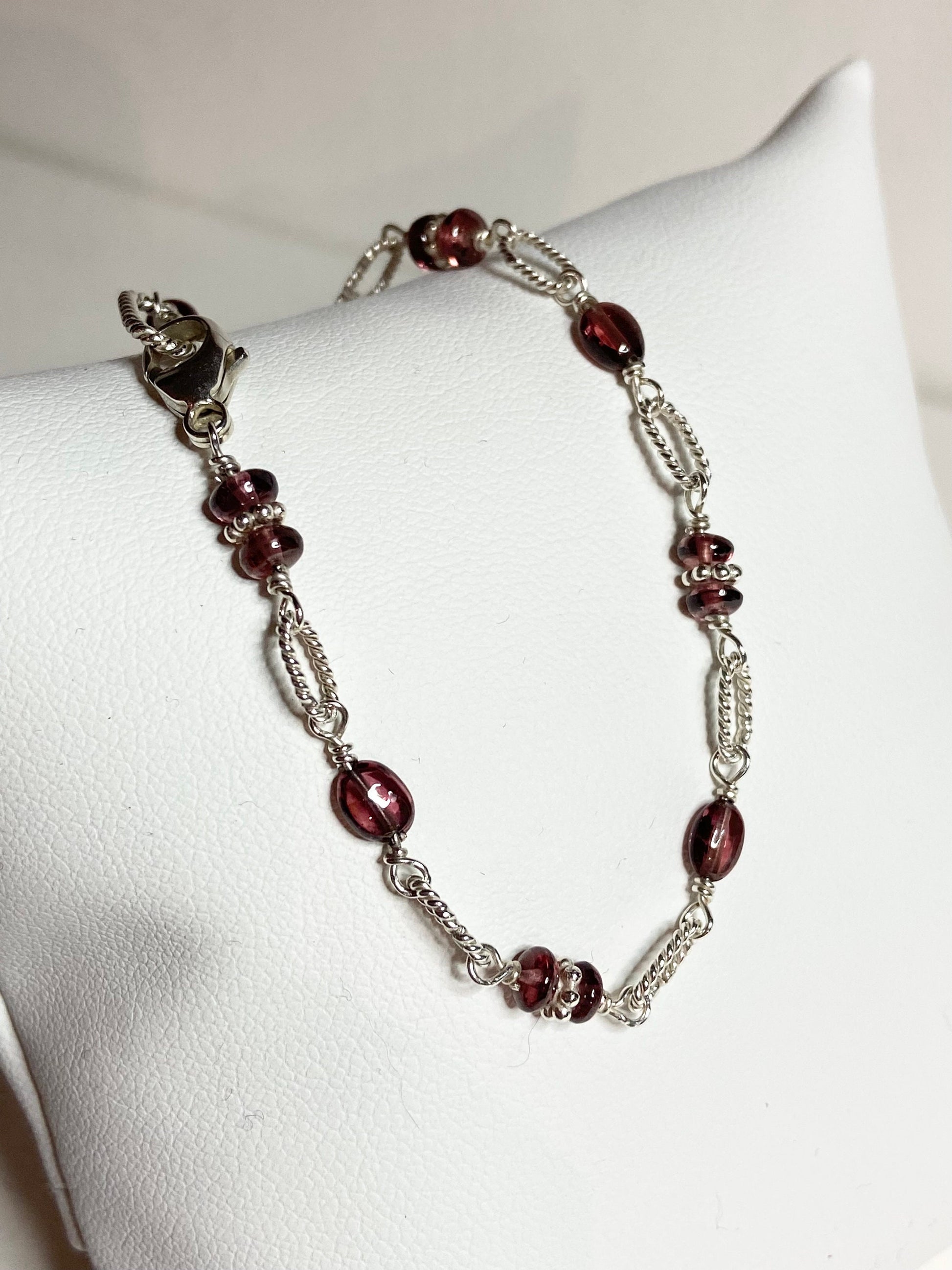 Malawi rhodolite garnet sterling silver beaded bracelet with a lobster clasp.