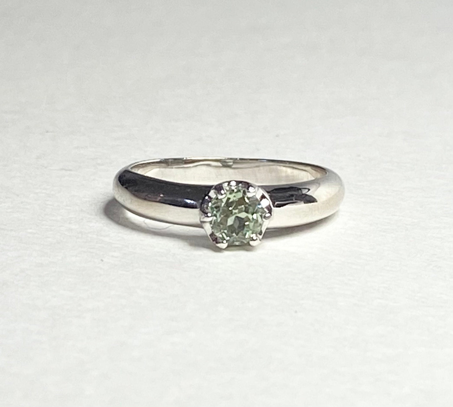Sterling silver ring with a green chrysoberyl solitaire stone.