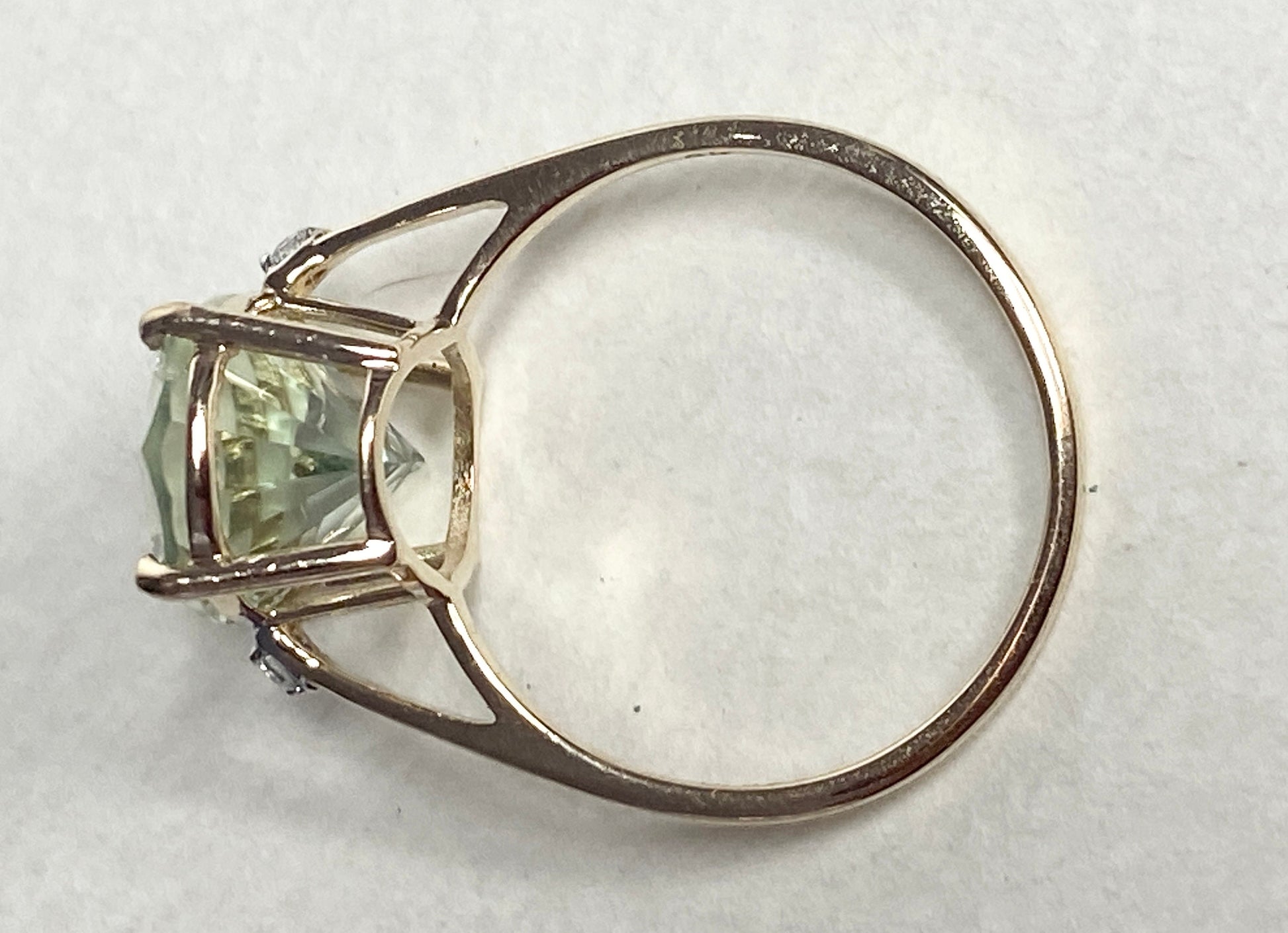9k yellow gold ring with a large oval prasiolite green quartz and two zircon stones.