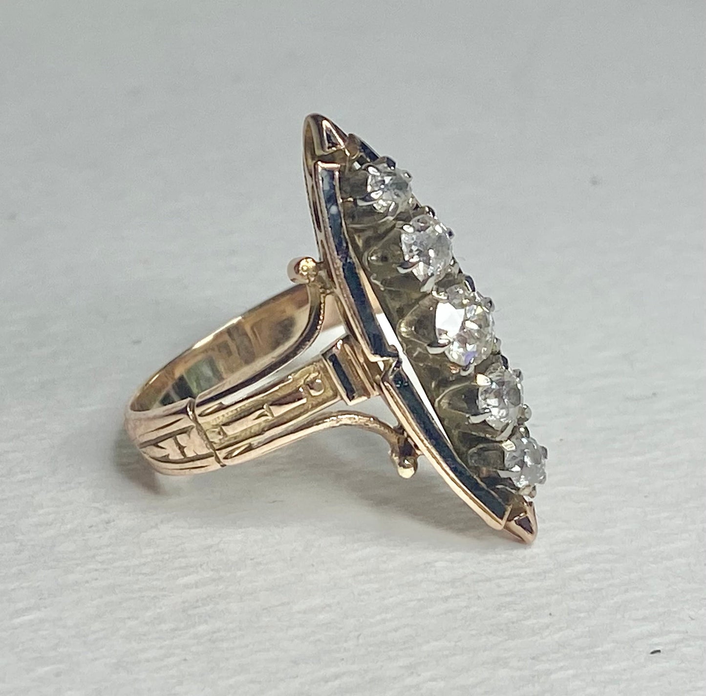 Antique Victorian navette ring with five old mine cut diamonds and black enamel.
