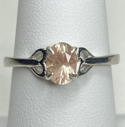 Sterling silver ring with a light peach oval Oregon sunstone and heart-shaped accents.