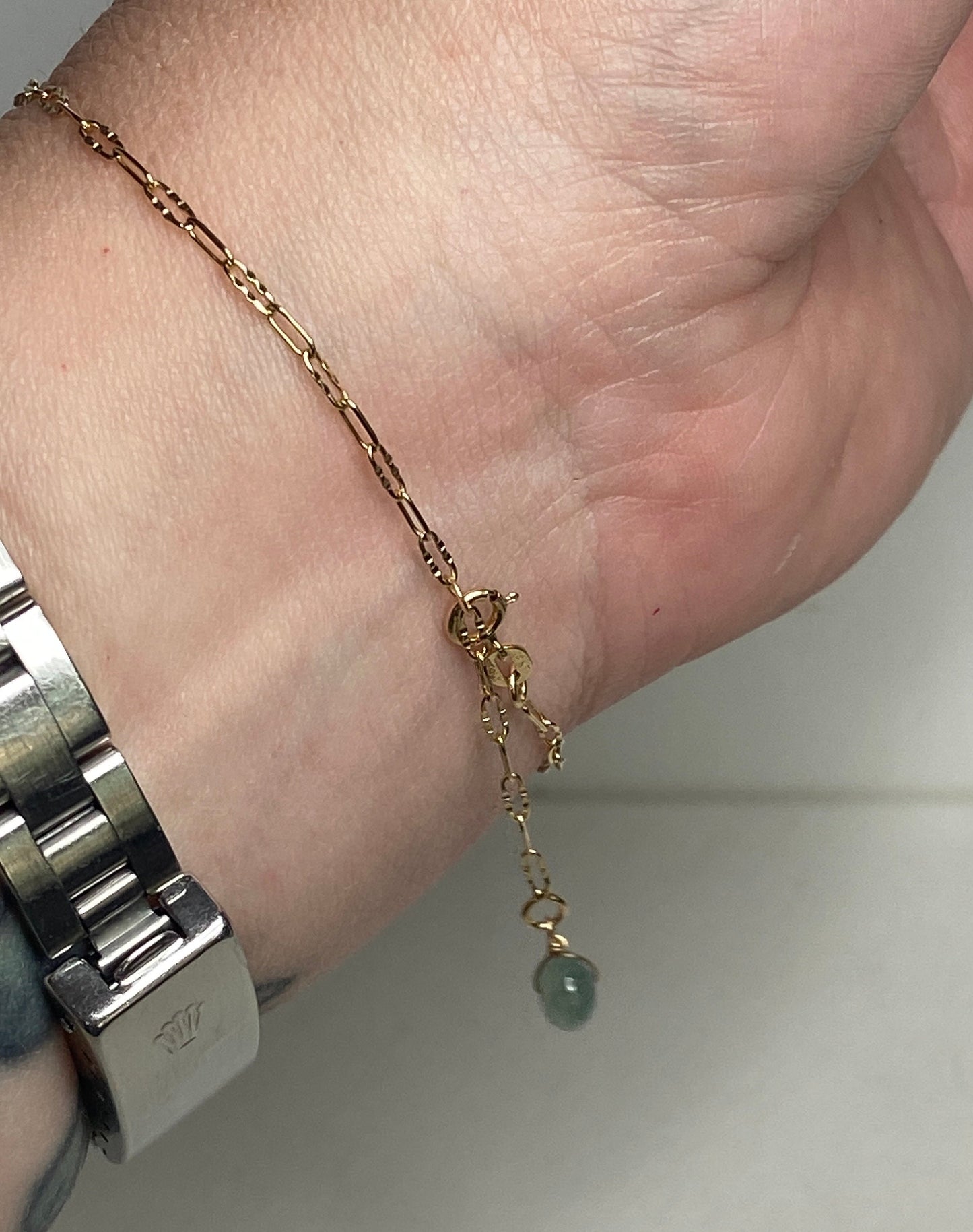 14k gold adjustable bracelet with a Type A Burmese jadeite jade Pi donut charm.
