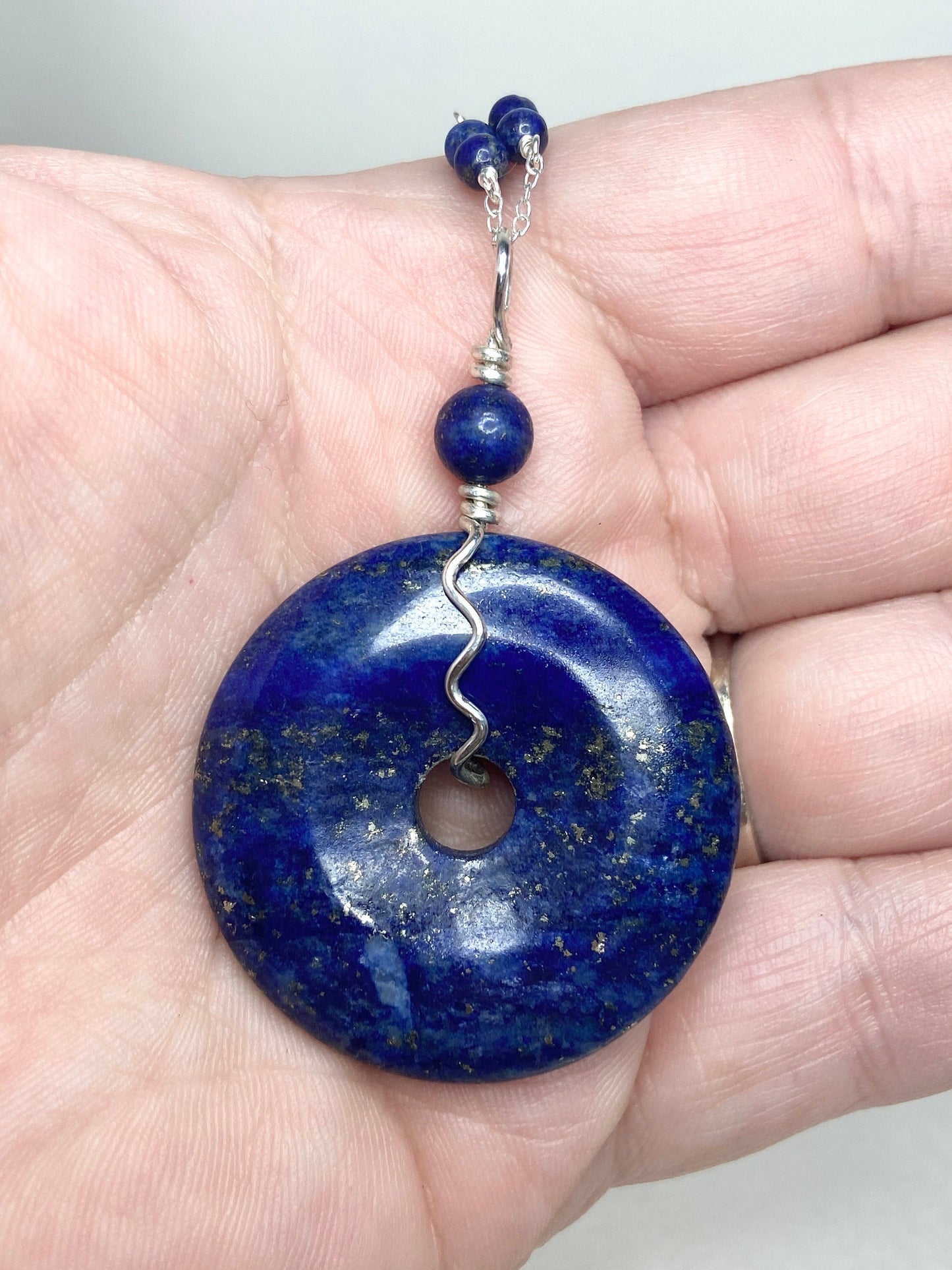 Lapis lazuli donut pendant necklace with sterling silver chain and beads.