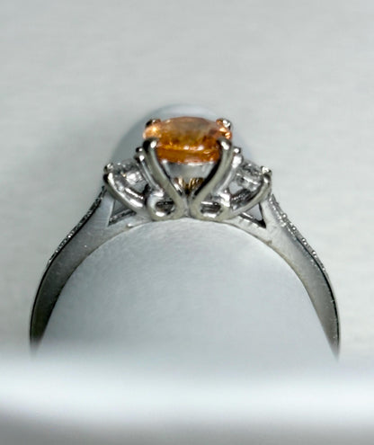A 10k white gold ring with a Fanta orange spessartite garnet and diamonds.