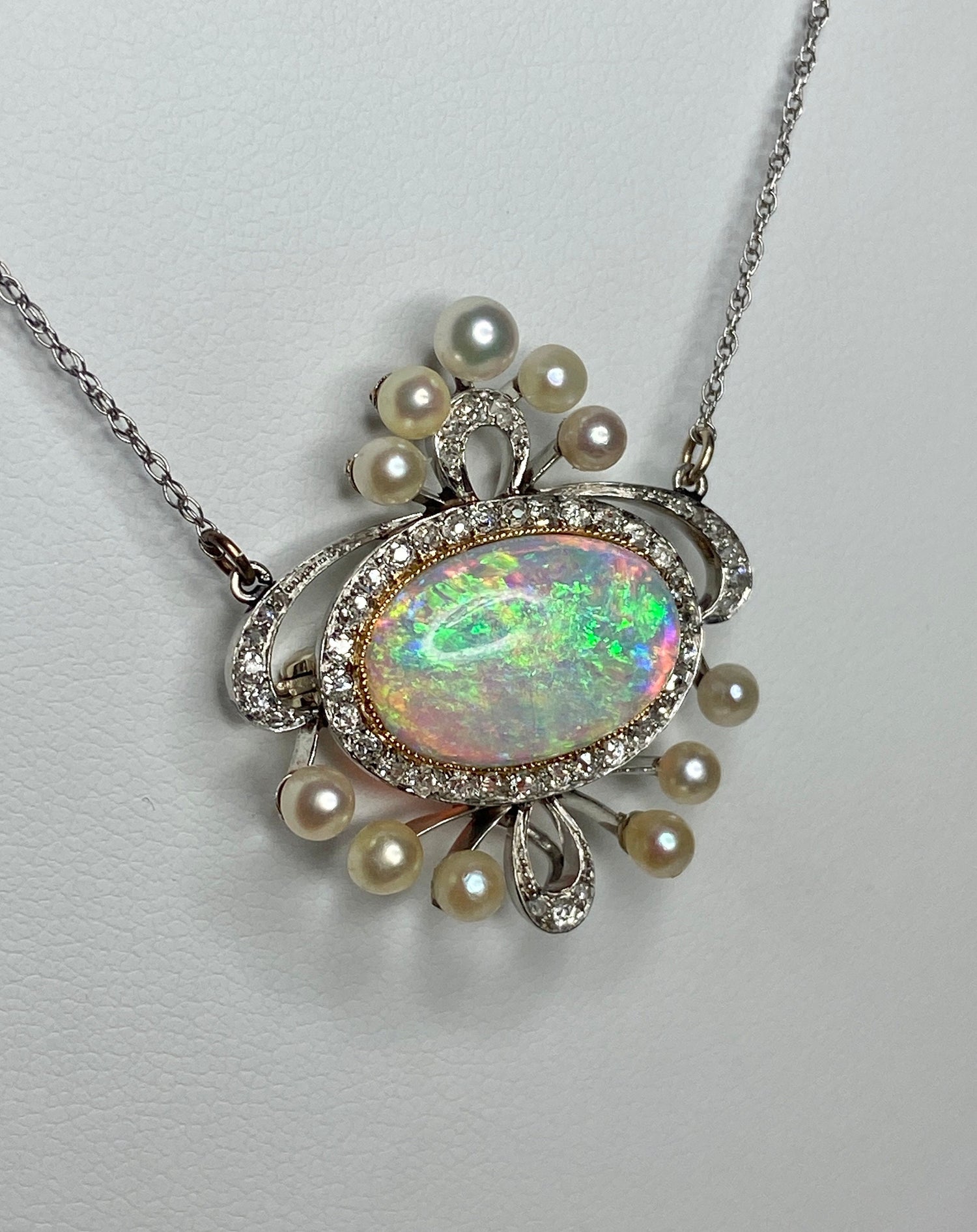 Platinum, 18k, and 14k gold necklace with opal, pearls, and diamonds.