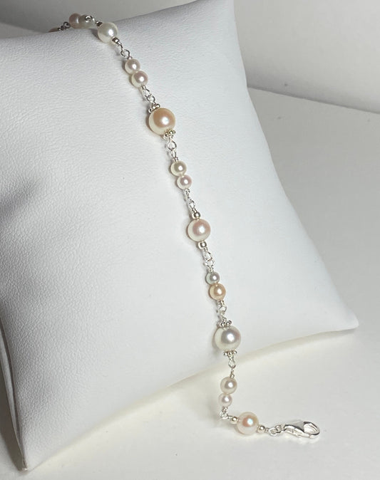 Sterling silver bracelet with multi-colored and sized Akoya pearls.