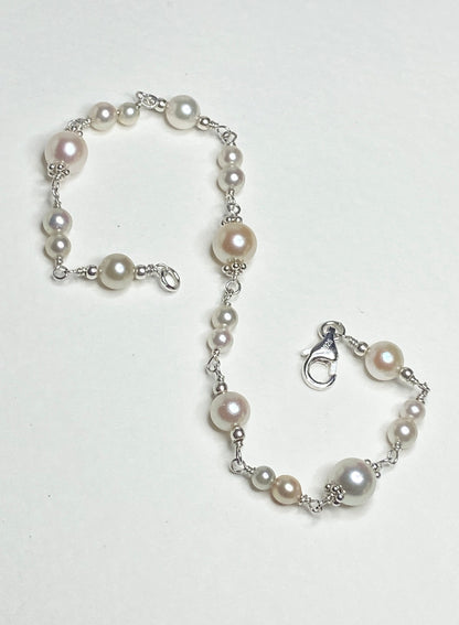 Sterling silver bracelet with multi-colored and sized Akoya pearls.