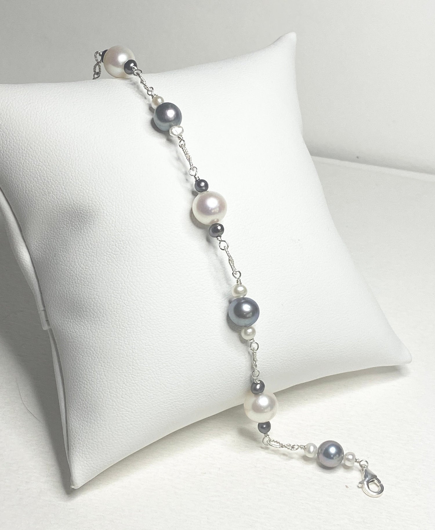 Sterling silver bracelet with Akoya, Tahitian, and freshwater pearls in black and white.