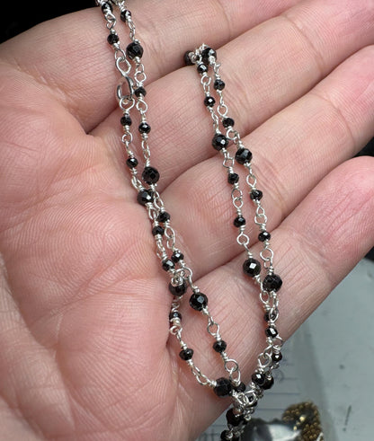 Sterling silver necklace with faceted black diamond beads.