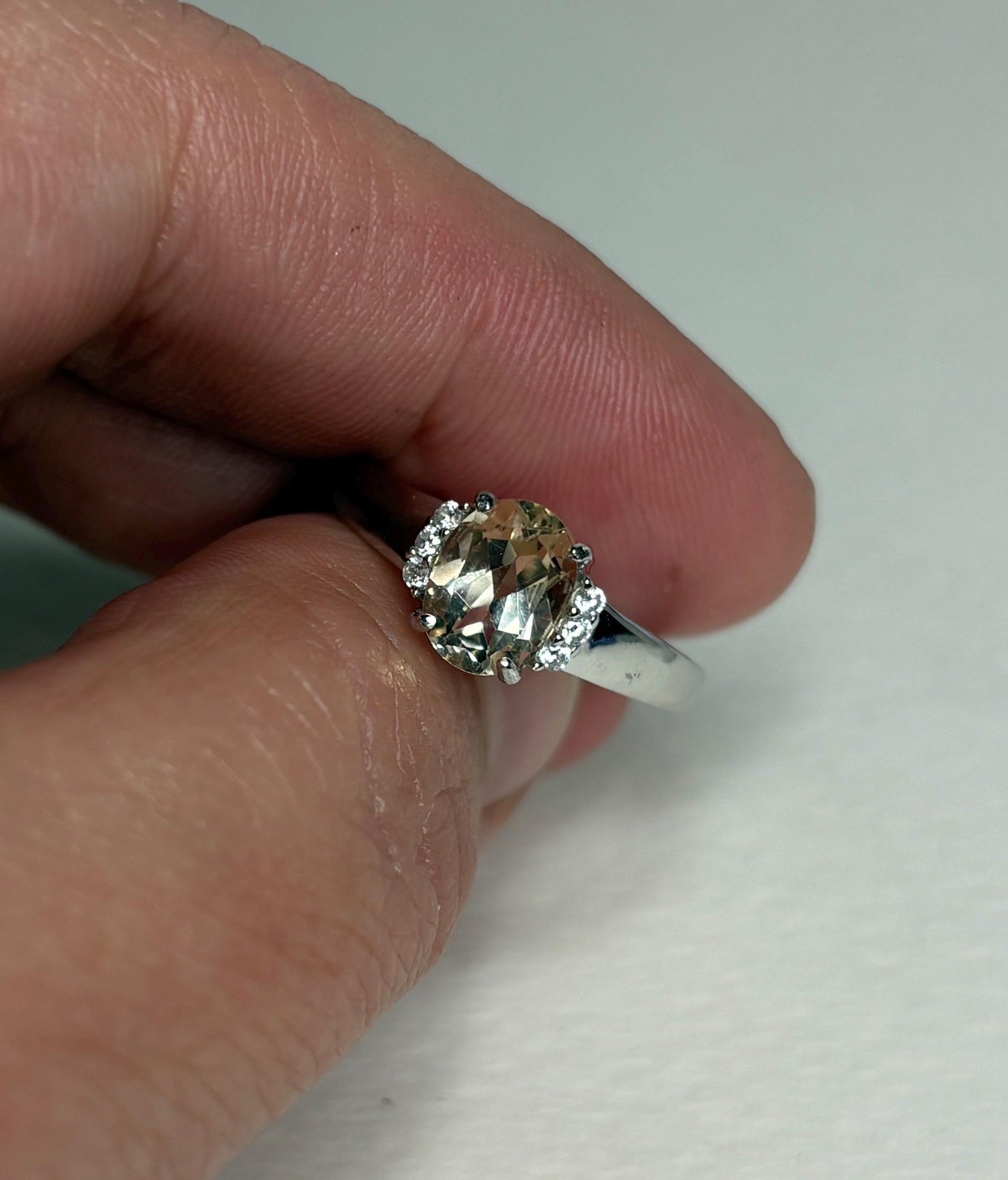Sterling silver ring with an oval Oregon sunstone and accent crystals.