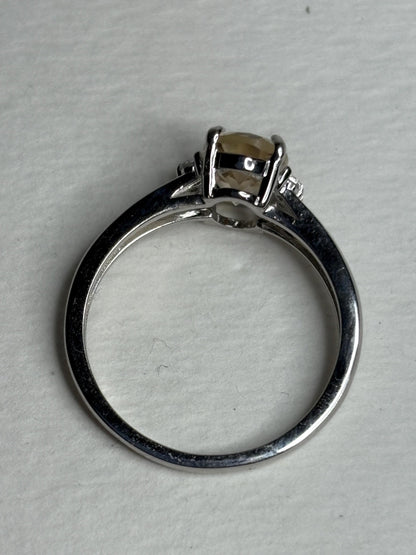 Sterling silver ring with an oval Oregon sunstone and accent crystals.