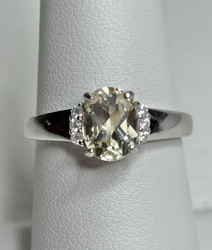 Sterling silver ring with an oval Oregon sunstone and accent crystals.