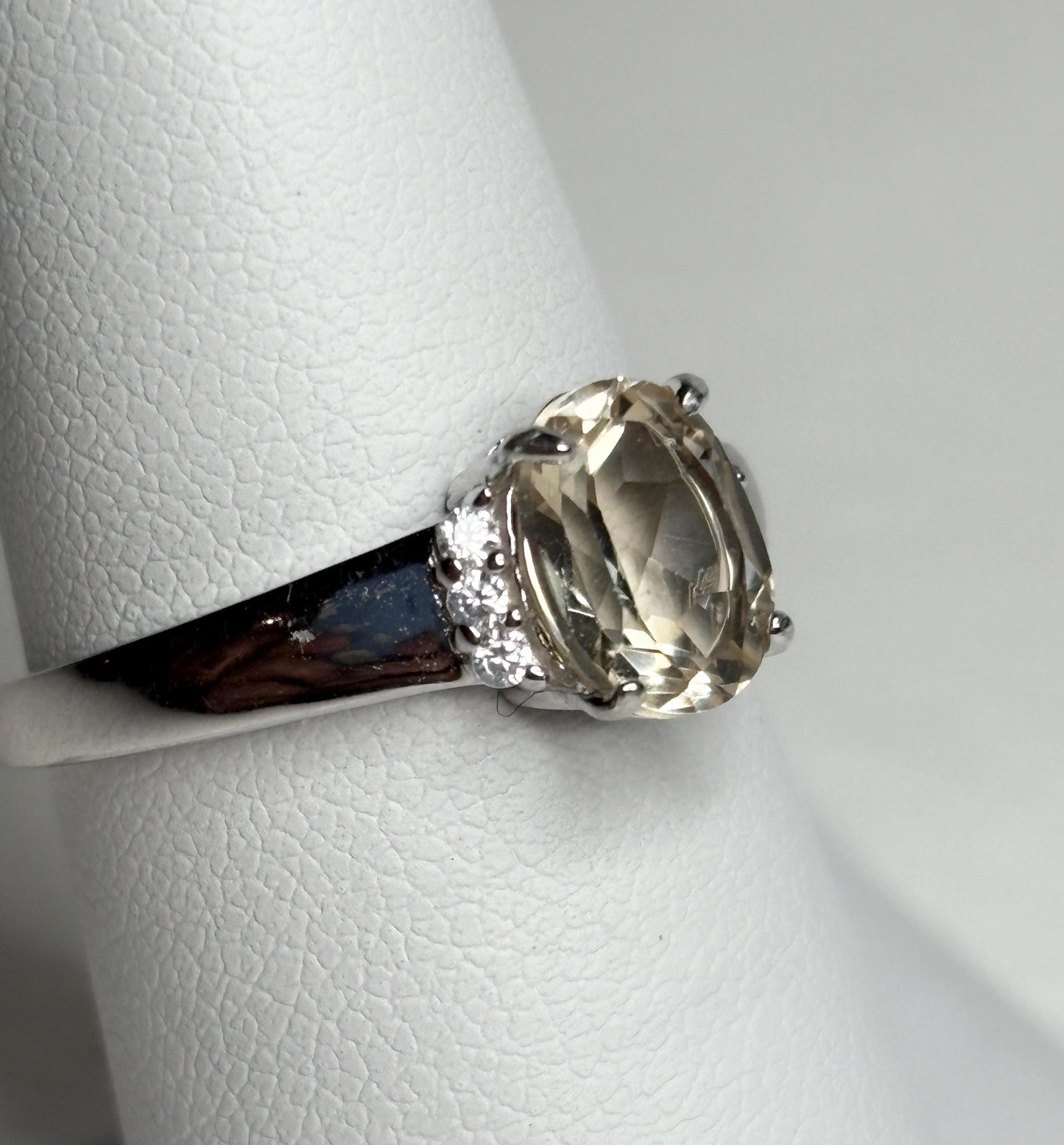 Sterling silver ring with an oval Oregon sunstone and accent crystals.