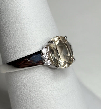 Sterling silver ring with an oval Oregon sunstone and accent crystals.