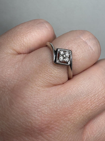 Natural diamond square cluster ring with milgrain detail in 10k white gold.