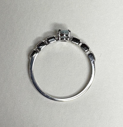 Sterling silver ring with a light blue oval tourmaline and crystal accents.