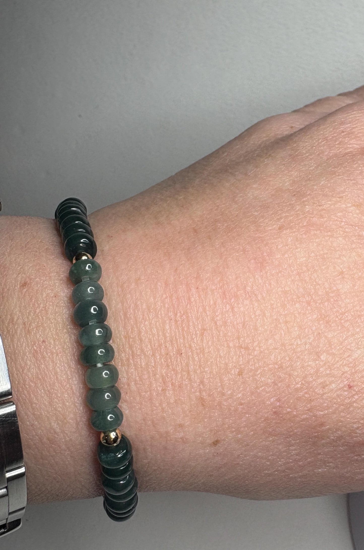 Guatemalan Type A jadeite jade stretch bracelet with gold beads.