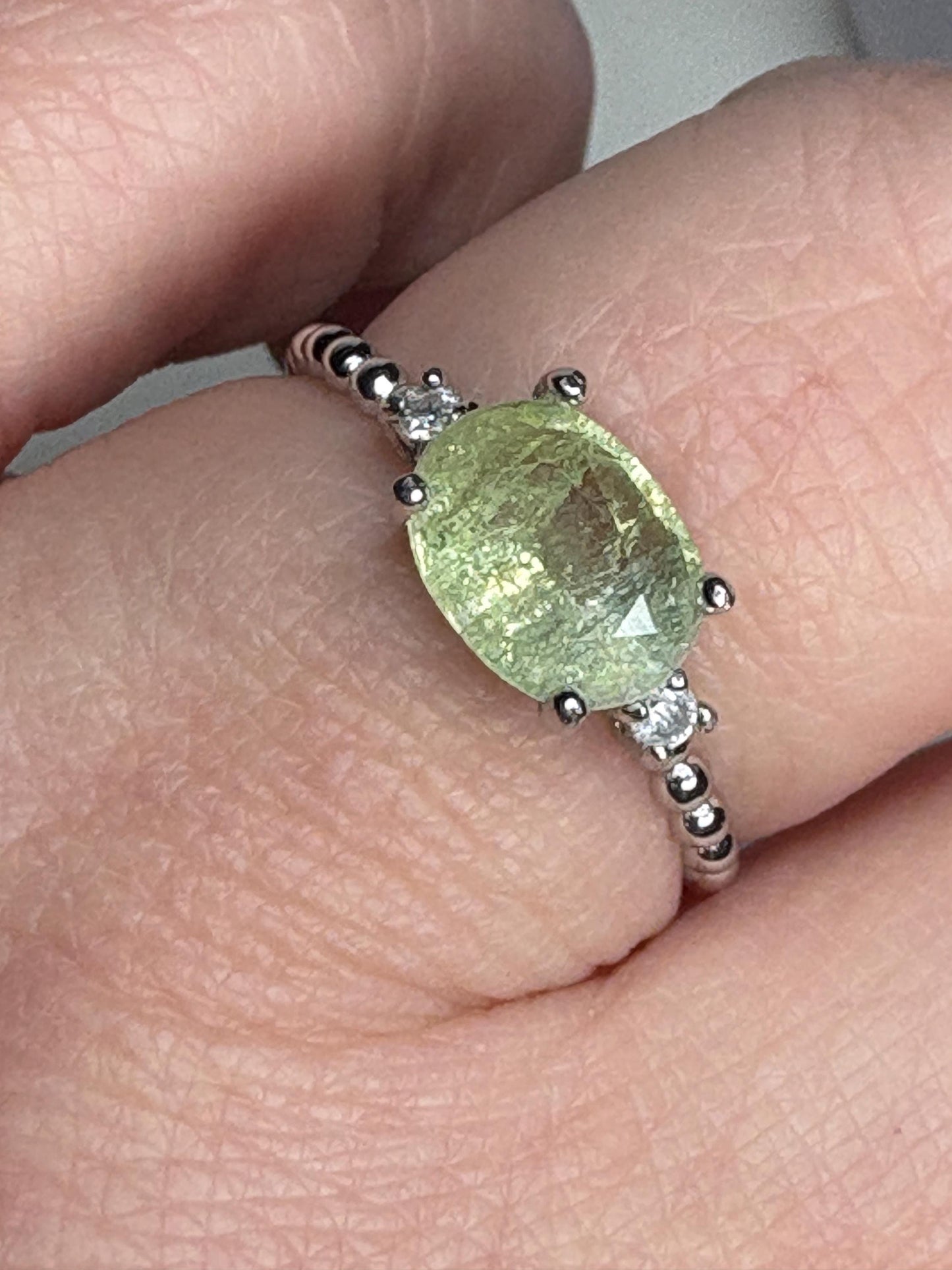 Sterling silver ring with a green cuprian tourmaline and diamonds.