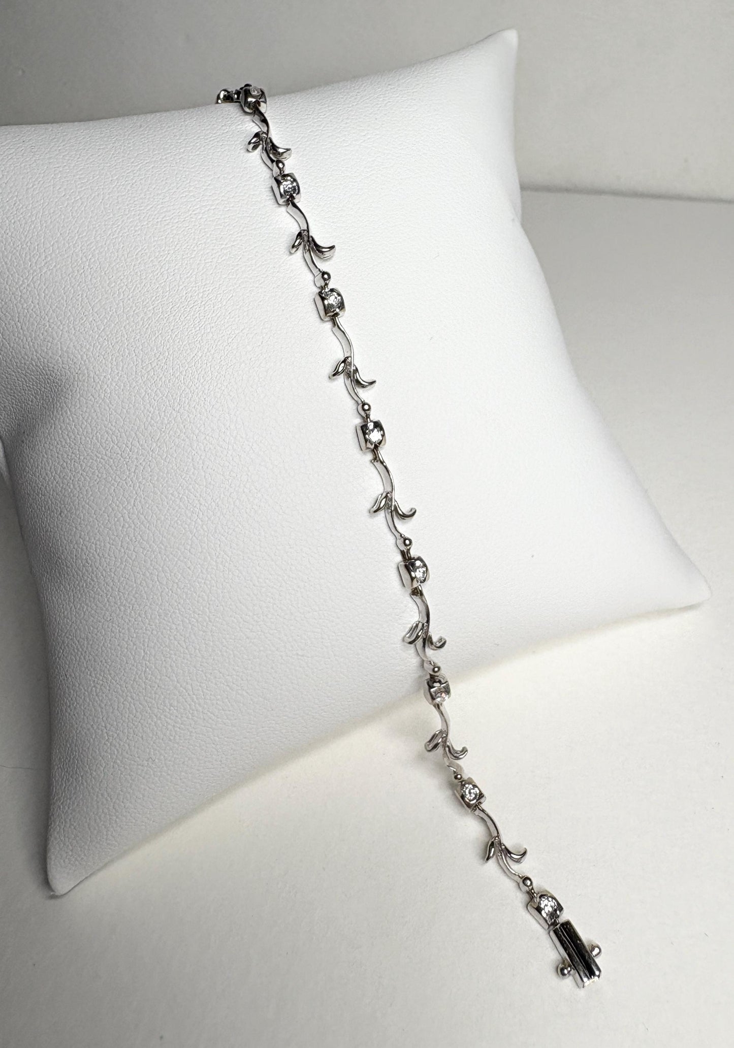 Solid 18k white gold bracelet with natural diamonds and vine links.
