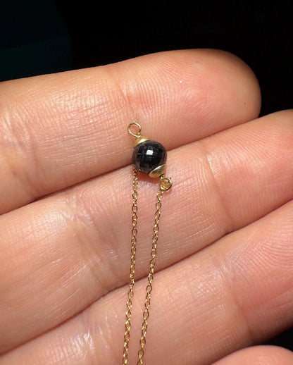 Solid 14k gold bracelet with a faceted black diamond bead.