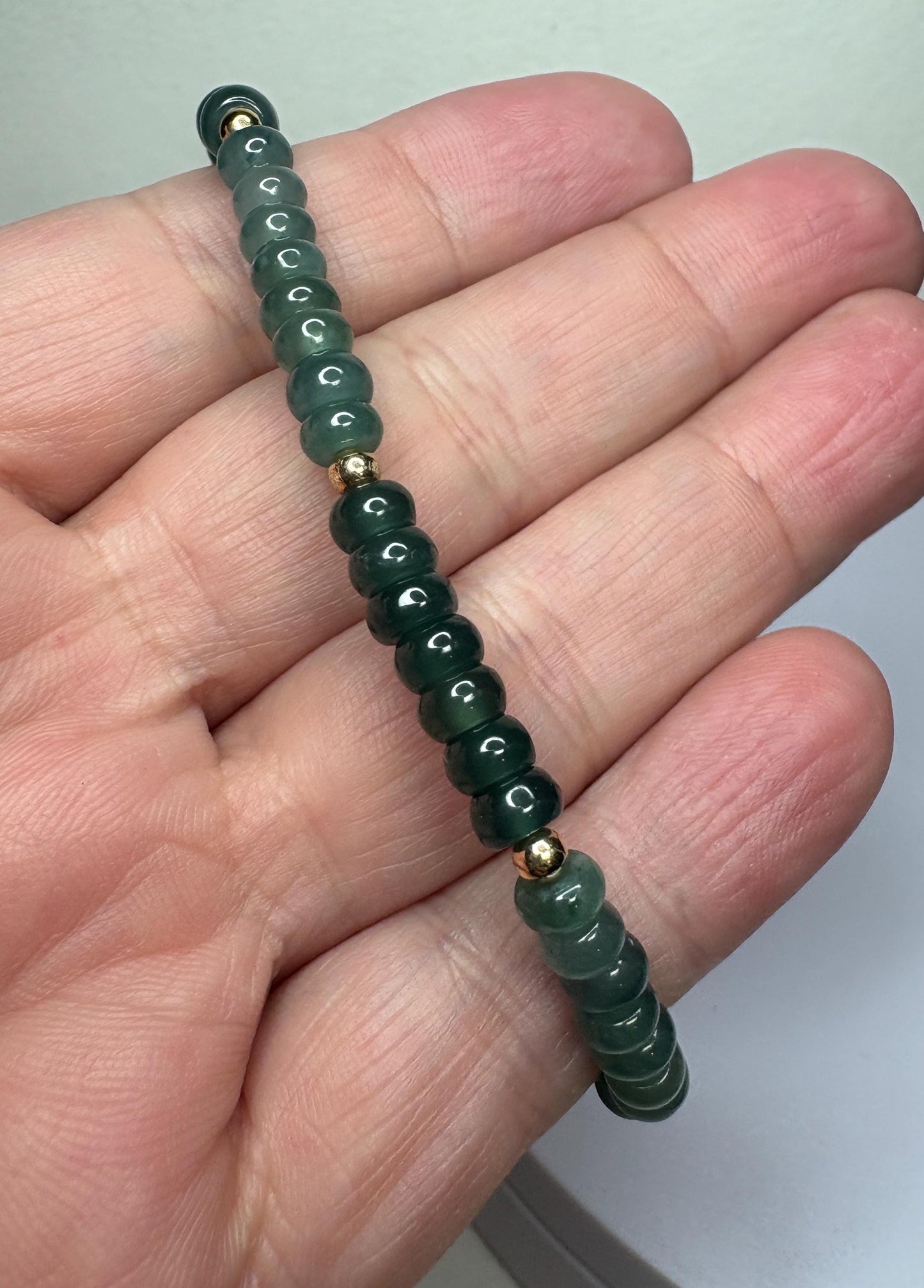 Guatemalan Type A jadeite jade stretch bracelet with gold beads.