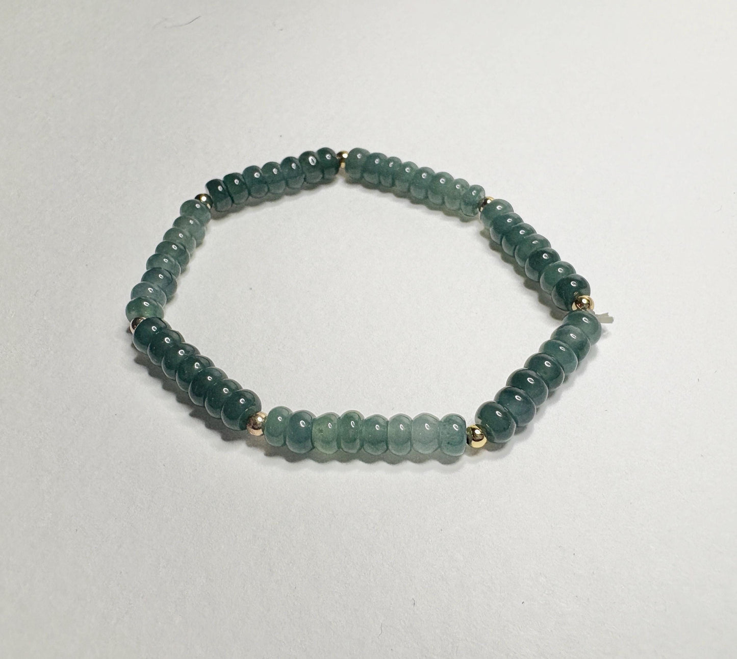 Guatemalan Type A jadeite jade stretch bracelet with gold beads.